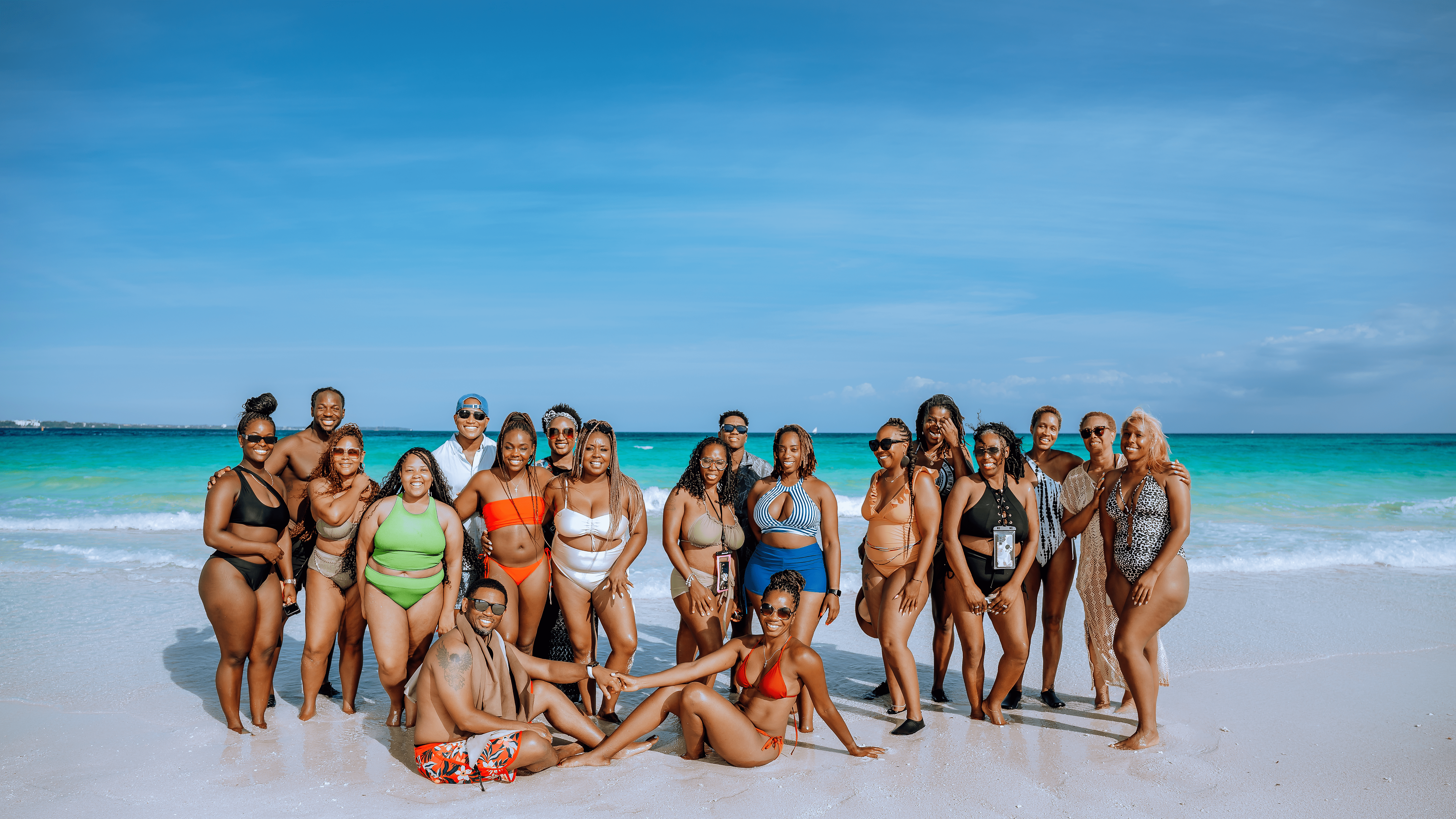 JetBlack Travel group on a turquoise-water Caribbean beach